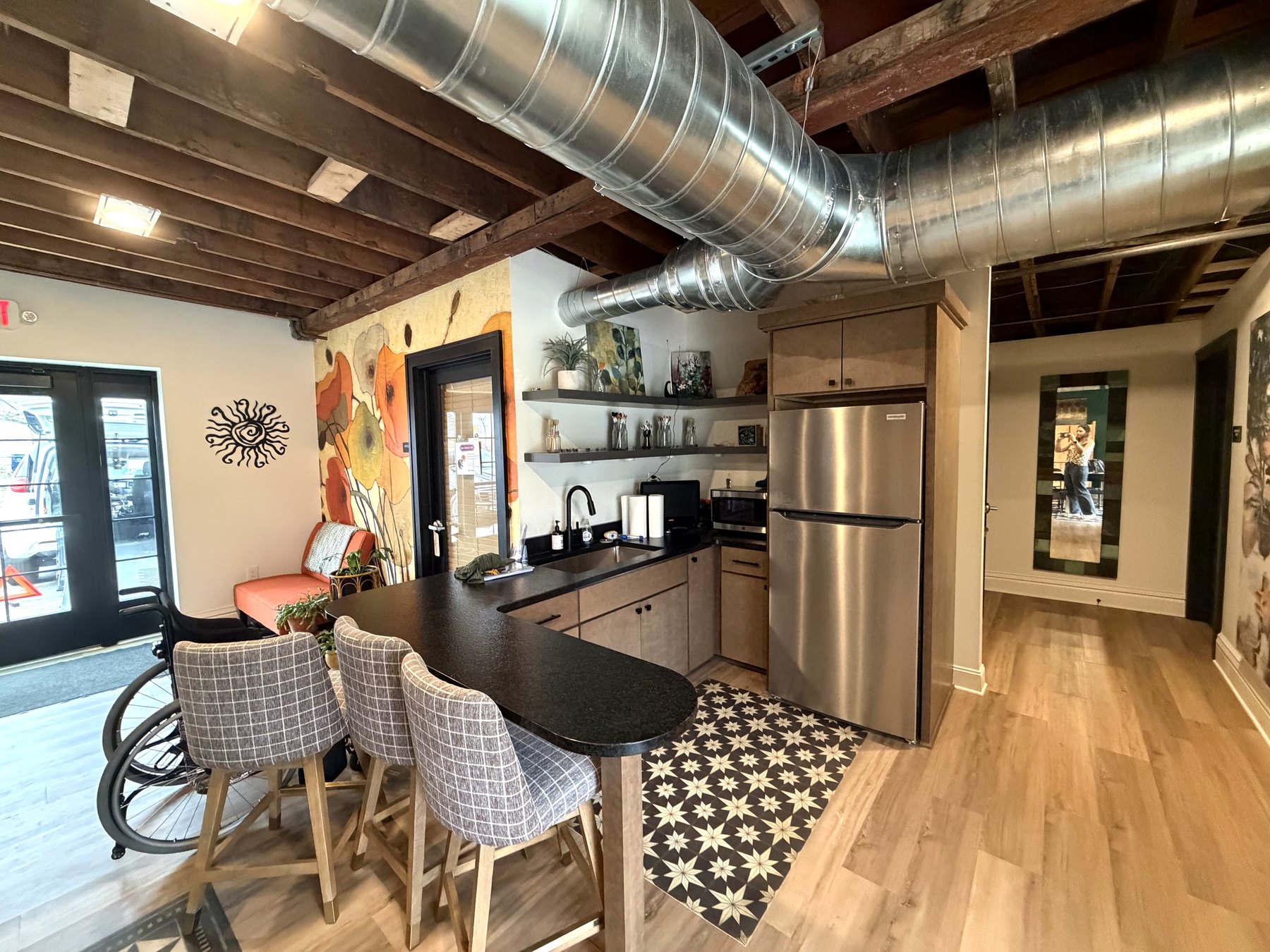 Small lounge seating and kitchenette inside Indigo Sun
