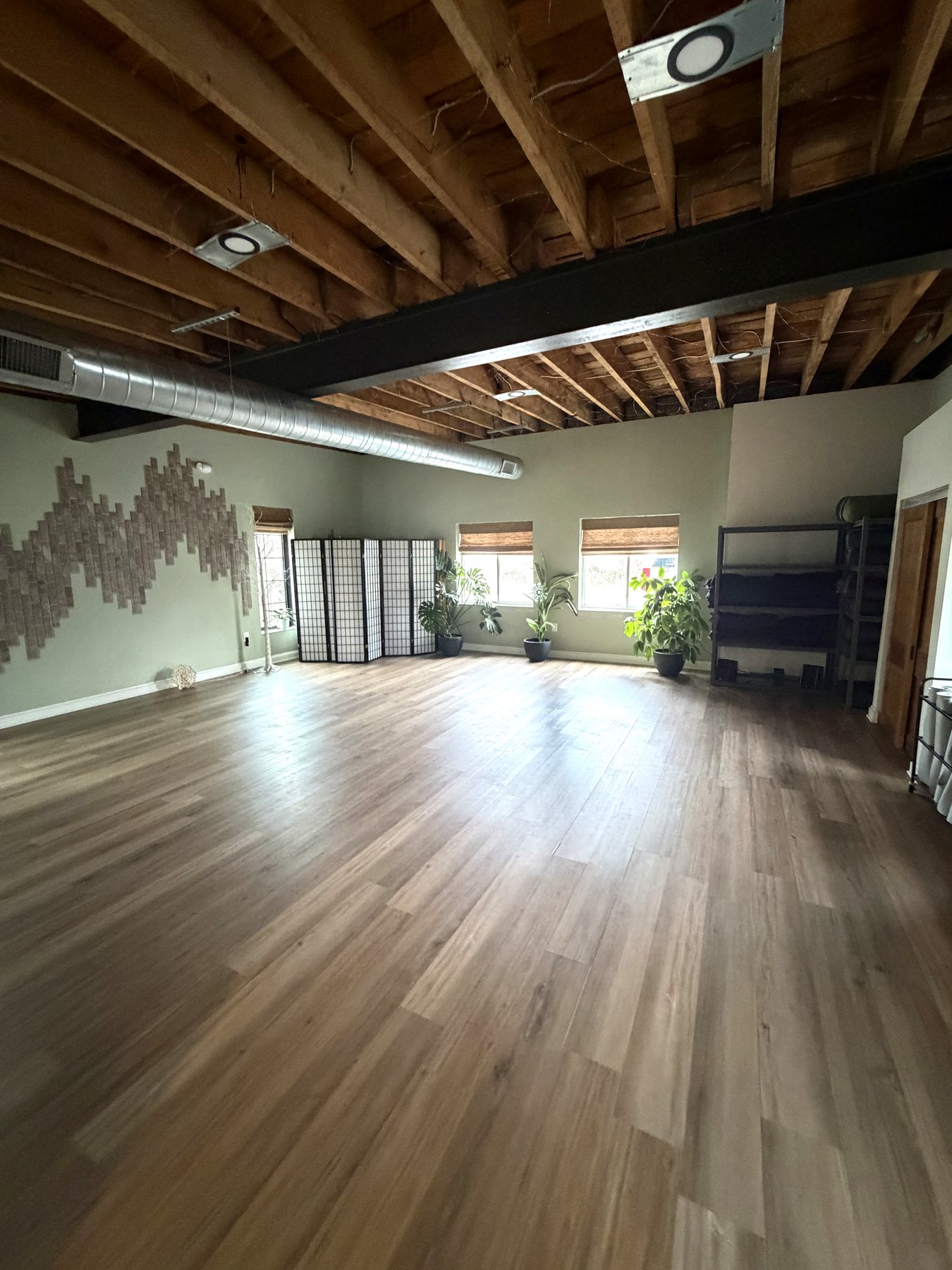 Open studio floor with mural wall and windows
